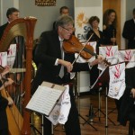 Norbet Heuser wowing Huntly children on a viola from the 1900s.