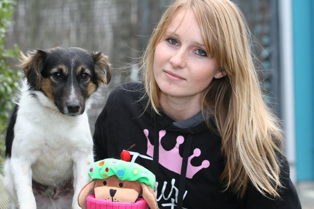 SPCA acting manager Hayley Port shares some love with abandoned dog Axel.