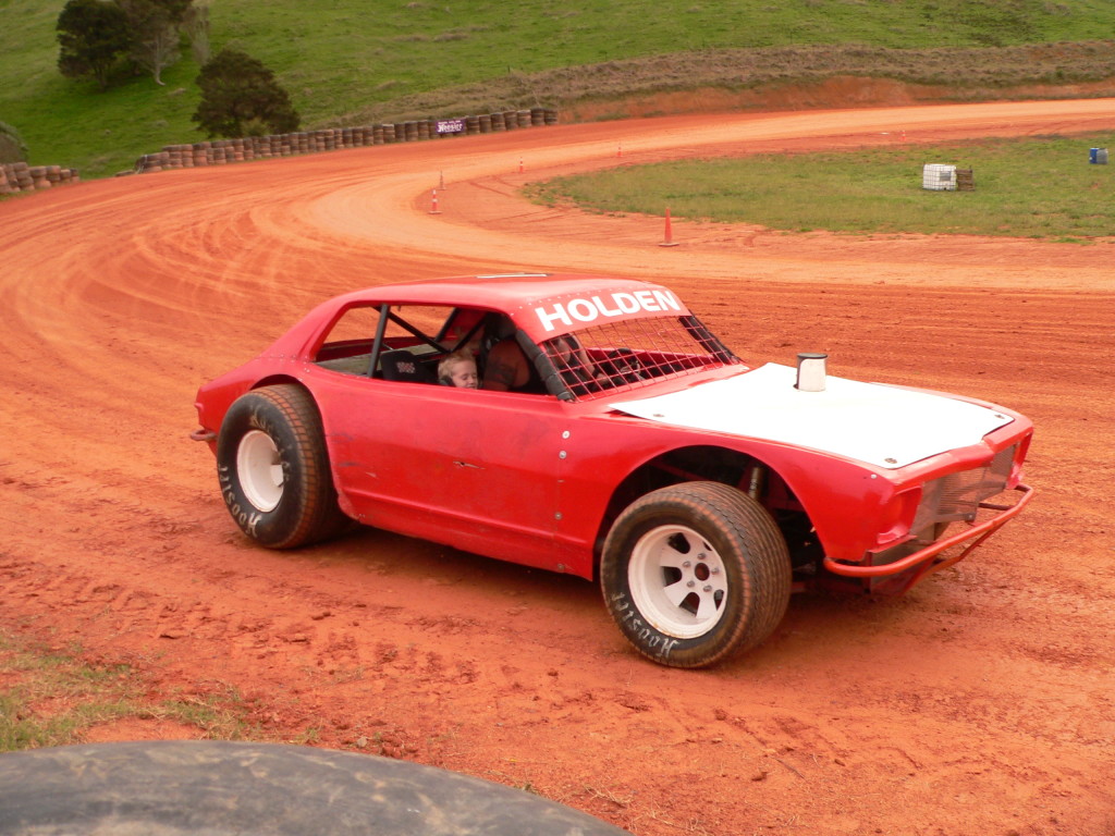 Pedal to the metal: a driver slides a speedway car into a bend on the Patetonga track.