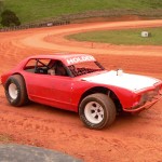 Pedal to the metal: a driver slides a speedway car into a bend on the Patetonga track.
