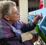 Finishing touches: Rose Gray paint tulips on her coffin to represent her Dutch heritage.