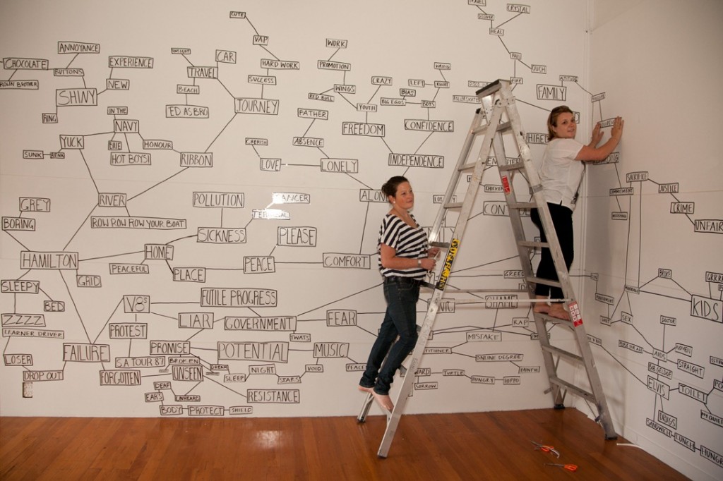 Let it grow: Alix Rogerson and Kate Symmans add words to the Ramp Gallery wall. 