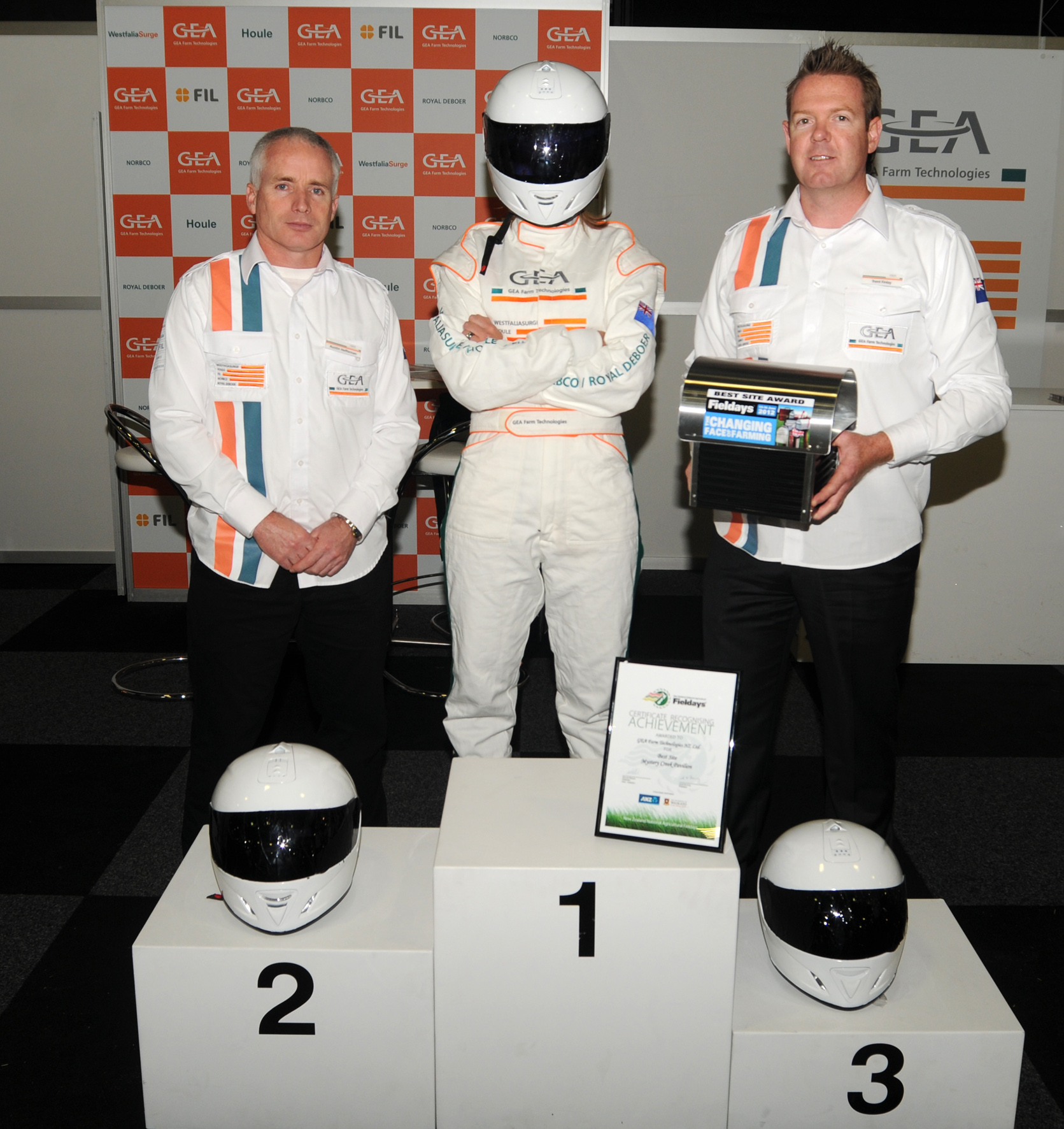 Austin Heffernan, Nicky Bowden (aka ‘The Stig’) and Trent Finlay of GEA Farm Technology celebrate winning the Best Mystery Creek Pavilion site at Fieldays. 