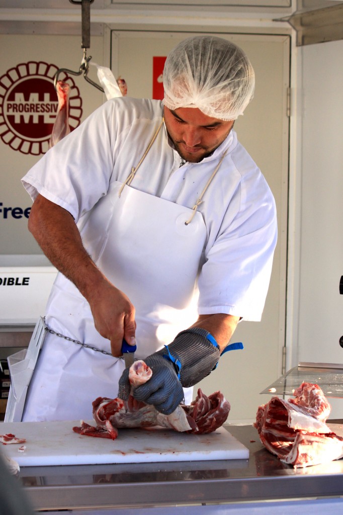 Photo: Garnett Rapana, 30, demonstrates his knife handling skills at the Te Kuiti Meats mobile butchery Photo: Adam Edwards