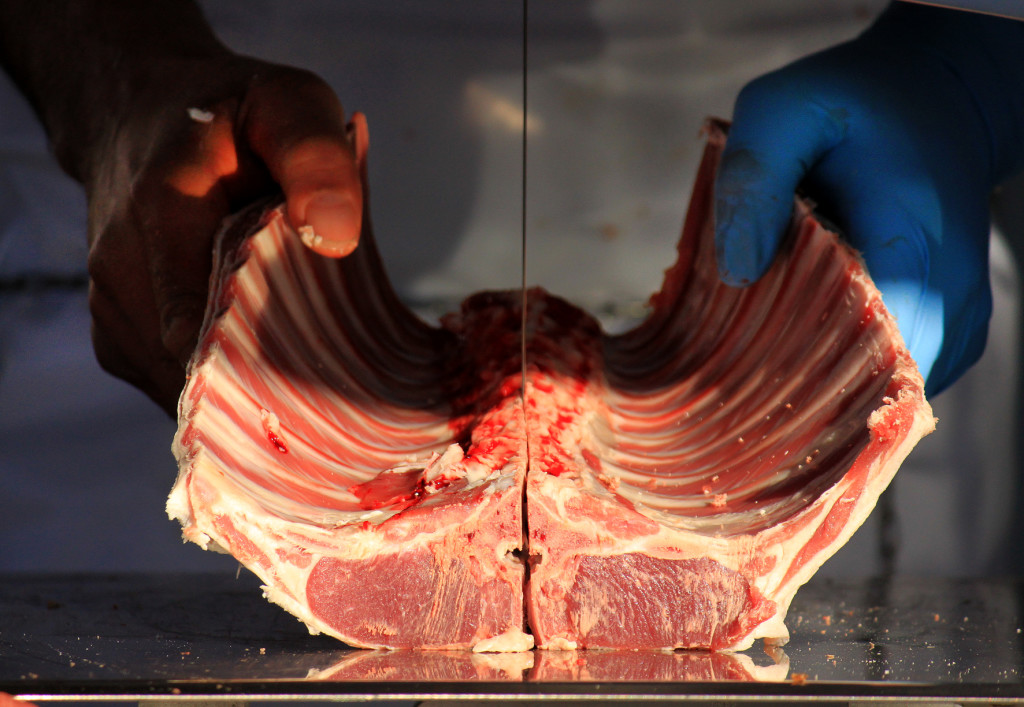 Photo: Garnett Rapana, 30, demonstrates his knife handling skills at the Te Kuiti Meats mobile butchery Photo: Adam Edwards