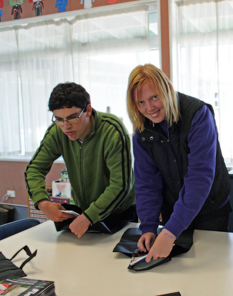 Caption: Lauchy Stewart and Samantha Barr pack the Fieldays programmes into seperate bags. Photos: Jennifer Robinson