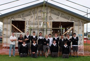 Carpentry Teacher with student in front of house - Photo by Samantha Smith