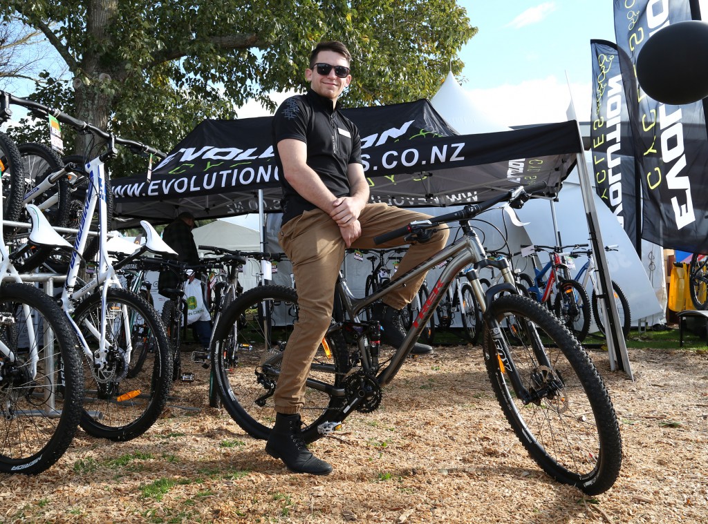 Cameron Ferguson at the Evolution Cycles stand. Photo: Naomi Johnston