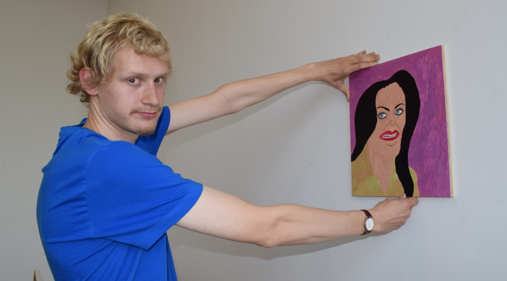 Wintec fine arts student Joseph Scott  with "Darkhorse", a portrait he did of pop star Katy Perry. Photo: David Nicoll