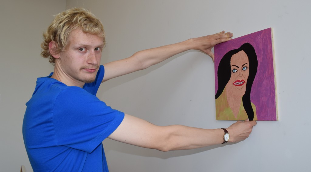 Wintec fine arts student Joseph Scott with "Darkhorse", a portrait he did of pop star Katy Perry. Photo: David Nicoll