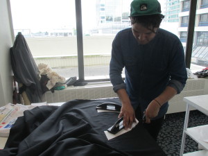 CUTTING IT CLOSE: Ari Brown works on one of his final garments