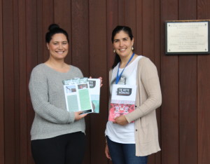 For the students: Kahurangi Waititi and Donna-Lee Biddle stand in front of the marae holding the third edition of the publication