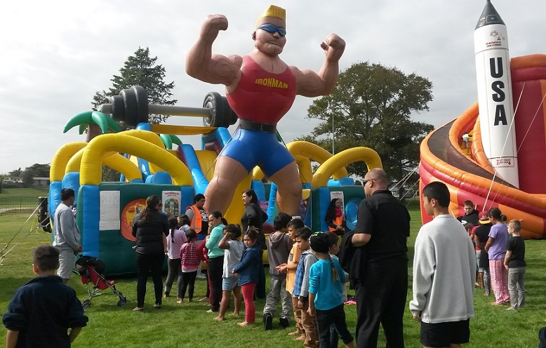 SCHOOL HOLIDAY FUN: Children line up at each of the Inflatables on offer. Photo: Shontelle Cargill