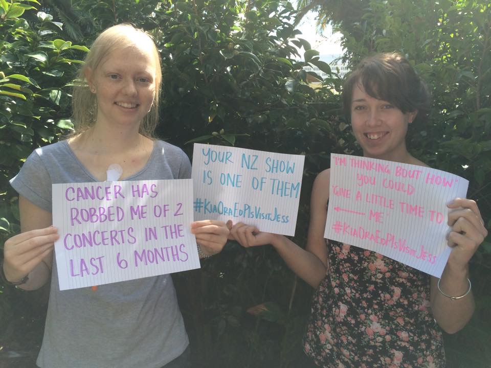 THE PHOTO THAT STARTED IT: Jessica Wright (left) and her friend Bryony Greene hold up signs with witty Sheeran lyrics and the hashtag #KiaOraEdPlsVisitJess