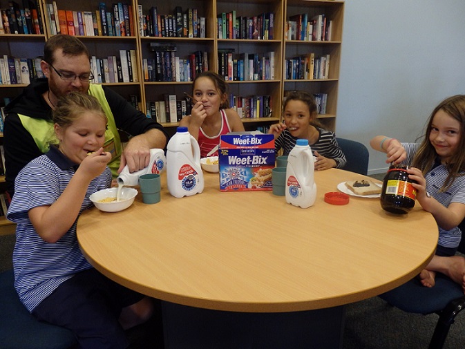 ANCHOR FAMILIES: Nicole McLean, Greg van de Worp, Trinity McDonald-Wilson, Geordie Humby and Sophie Burns making their anchor milk breakfast at before school care. Photo: Supplied.