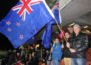 The hall family come out to support with New Zealand flags. From left to right: Tom, Ben and Arnie Hall