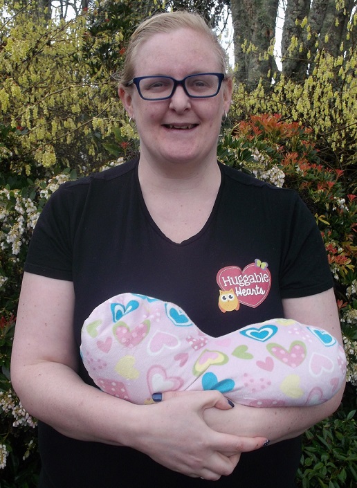 FABRIC HEART: Andrea Olliver-Thompson craddles one of her charity's huggable hearts. Photo: Shontelle Cargill