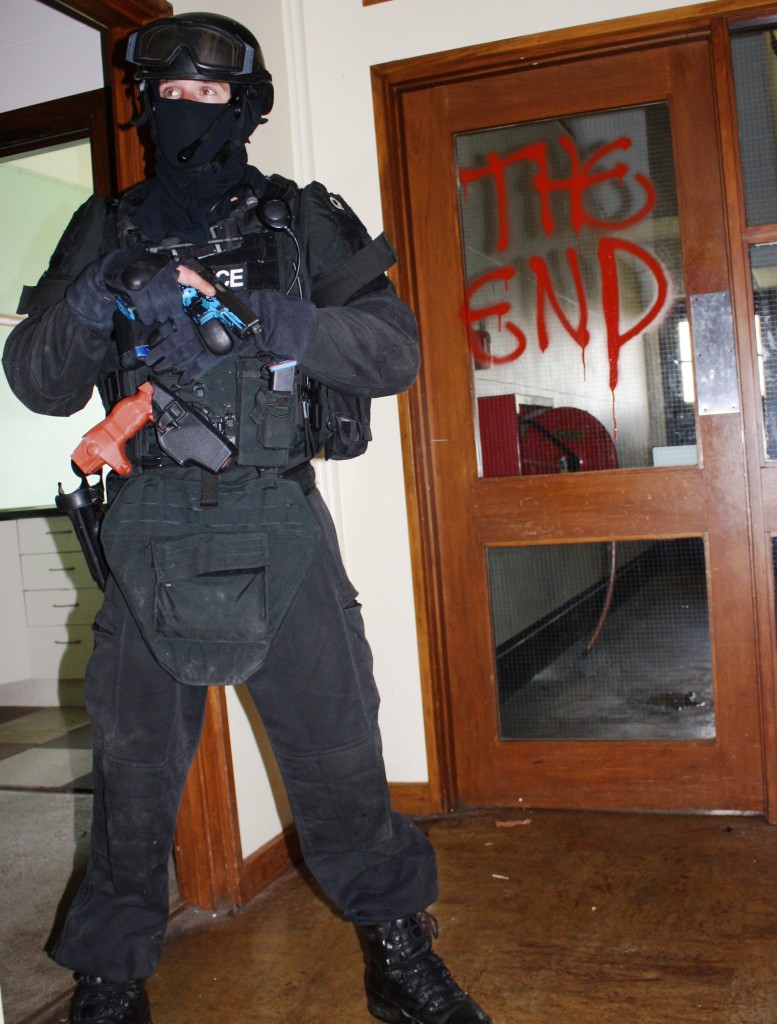 An AOS officer monitors the corridor during a training exercise. Photo: Supplied