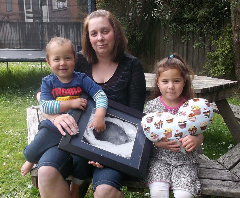 FAMILY:  Amie Whenuaroa with her children Addison and Lincoln, holding a photograph of her firstborn daughter Noelle. Photo: Shontelle Cargill