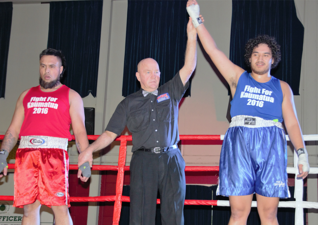 Levi "The Force" Awheto has his hand hoisted high by referee Denny Enright, after a win by knockout over Keri Winitana. Photo: Horiana Henderson