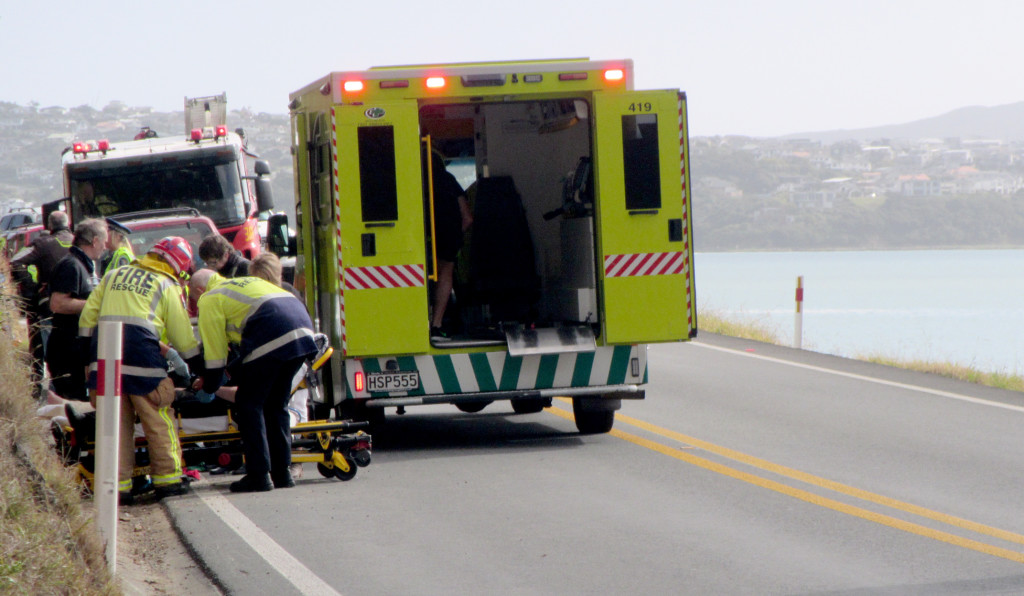 Traffic is diverted to one lane north of Wellington as a woman in a neck brace is loaded into an ambulance. Photo: Rachel Binning