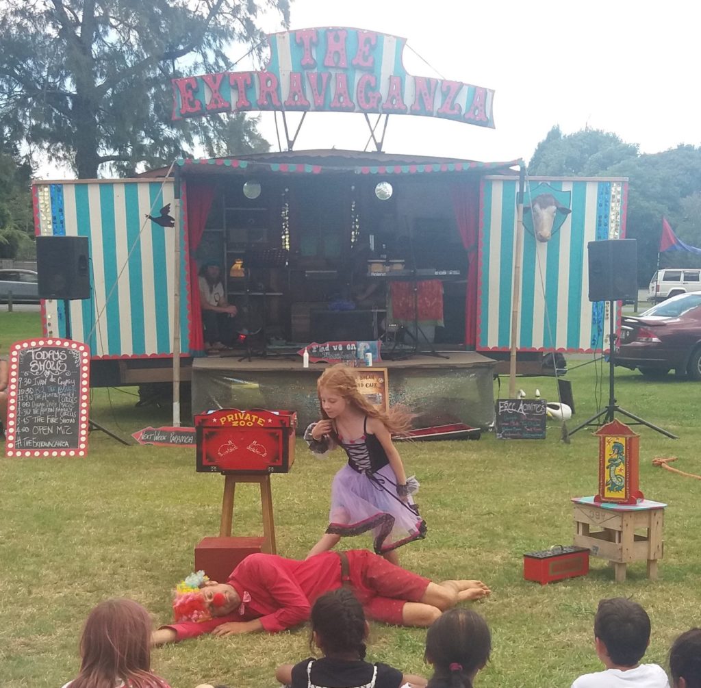 Children of Hamilton are glued to magician Dylan Ashton's performance - she is playing tricks on her dad Royce the Clown. Photo: Jesse Kiing